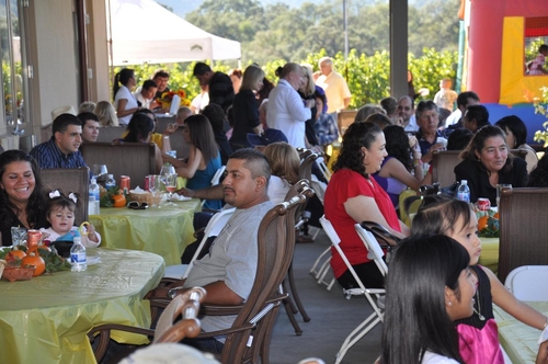 Parents and kids having fun at annual harvest part